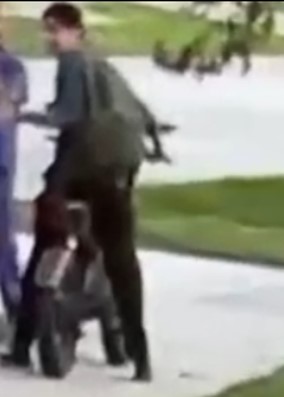 surveillance photo of young man on e-motor wearing black hat and backpack