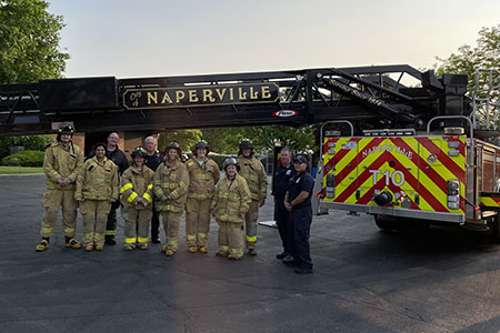 residents in bunker gear by fire truck