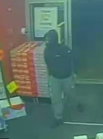 surveillance photo of suspect entering business