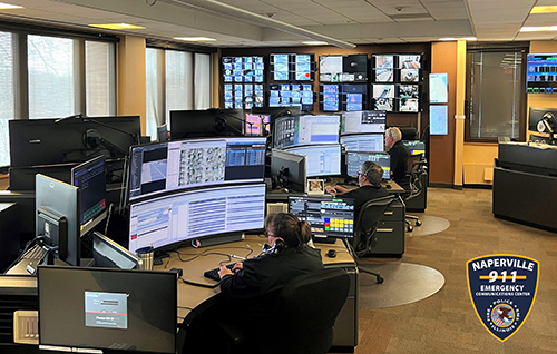 dispatchers sit at large computer terminals surrounded by screens and other technology
