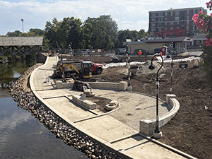 Work continues on the plazas that face the river, including the installation of lamp posts.