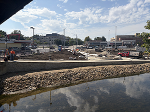 The sidewalks are laid out around the plazas that face the DuPage River.