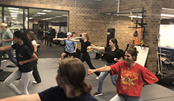 A large group of interns practice defensive tactics